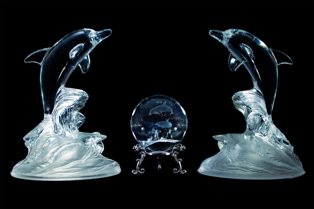 product display of glass dolphin sculptures