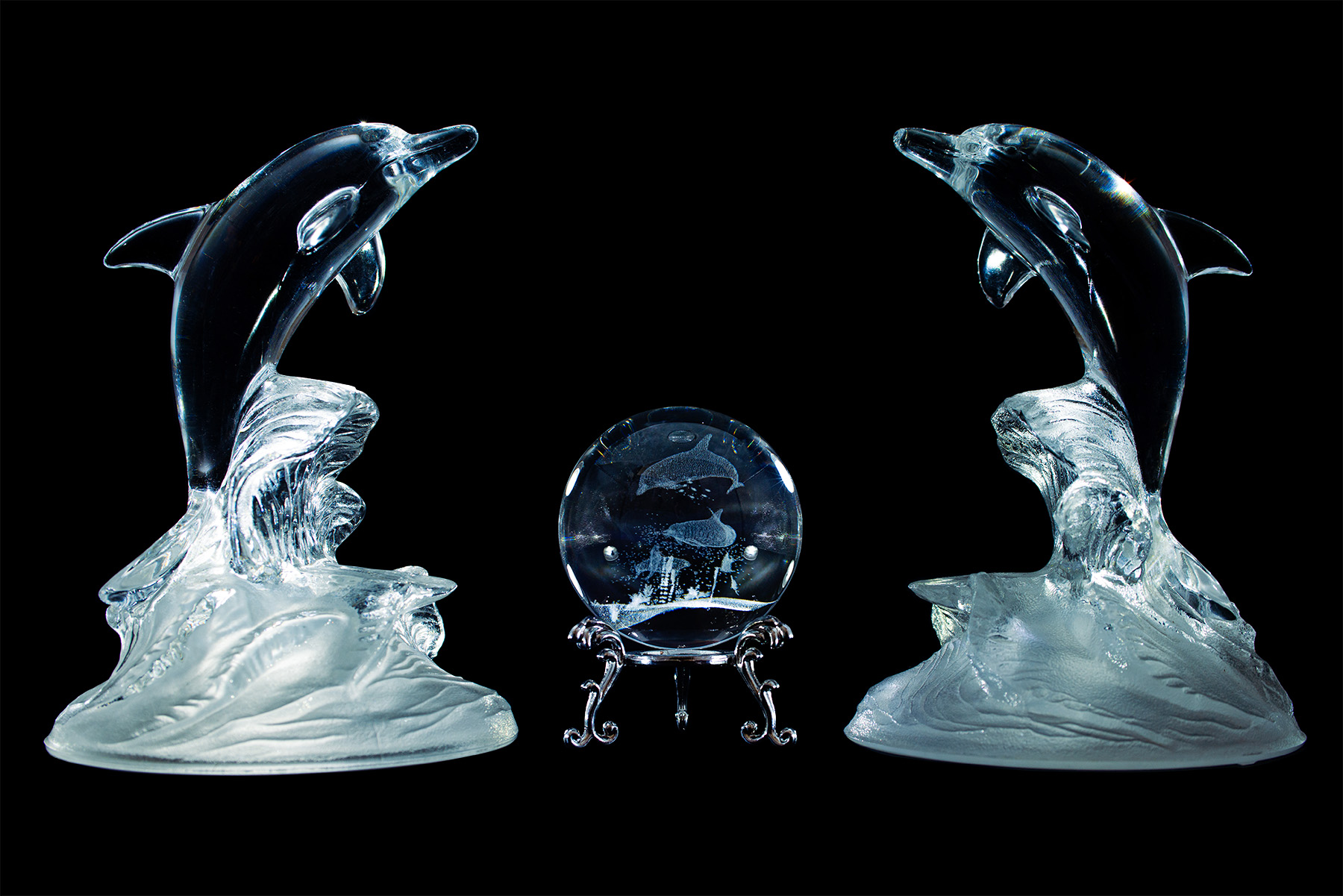 product display of glass dolphin sculptures
