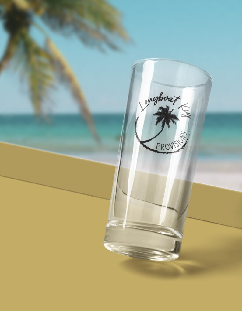 brand identity of logo placement on glassware in tropical setting for Longboat Key Provisions