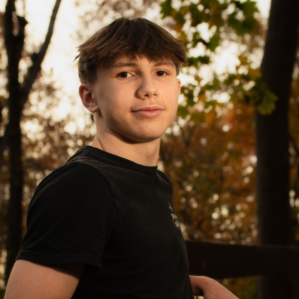 senior portrait photography of boy posing on stair railing in olmsted falls near cleveland