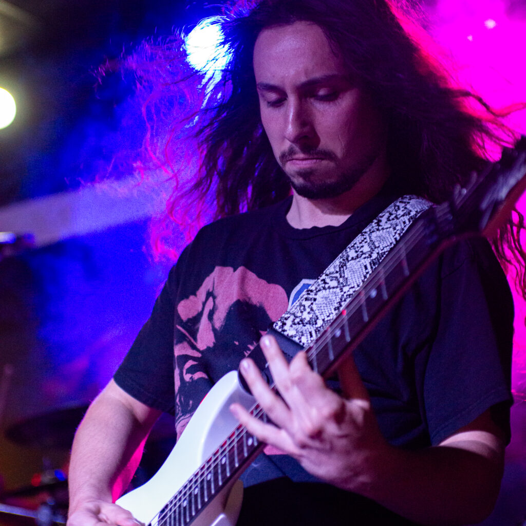 concert photography of Olathia guitarist at Beachland Tavern with white guitar and flowing hair